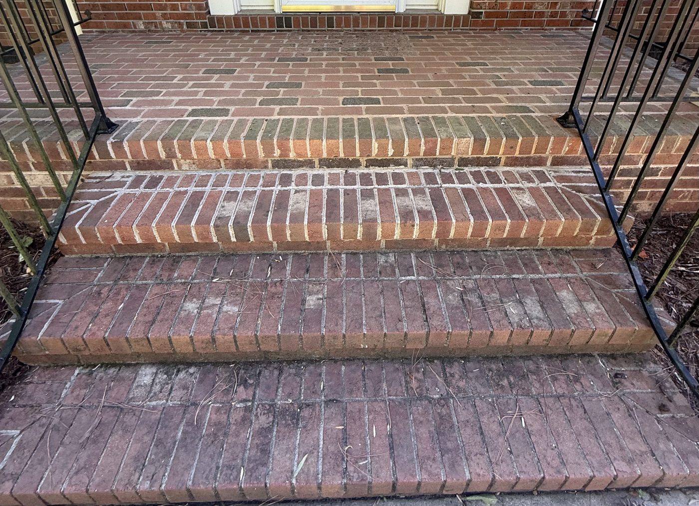 Brick front steps before pressure washing